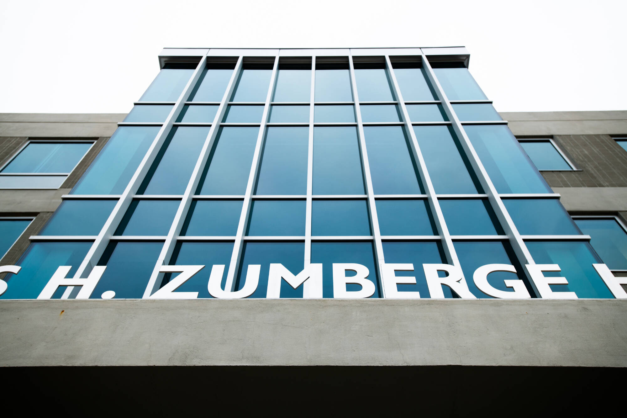 Front of James H. Zumberge Hall with focus on the name Zumberge.
